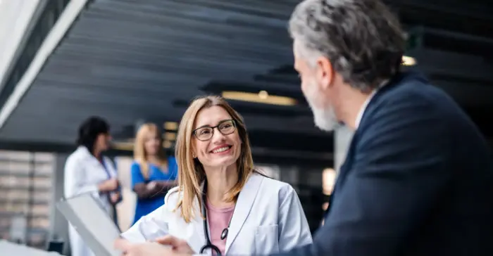 Image of a physician speaking with a representative